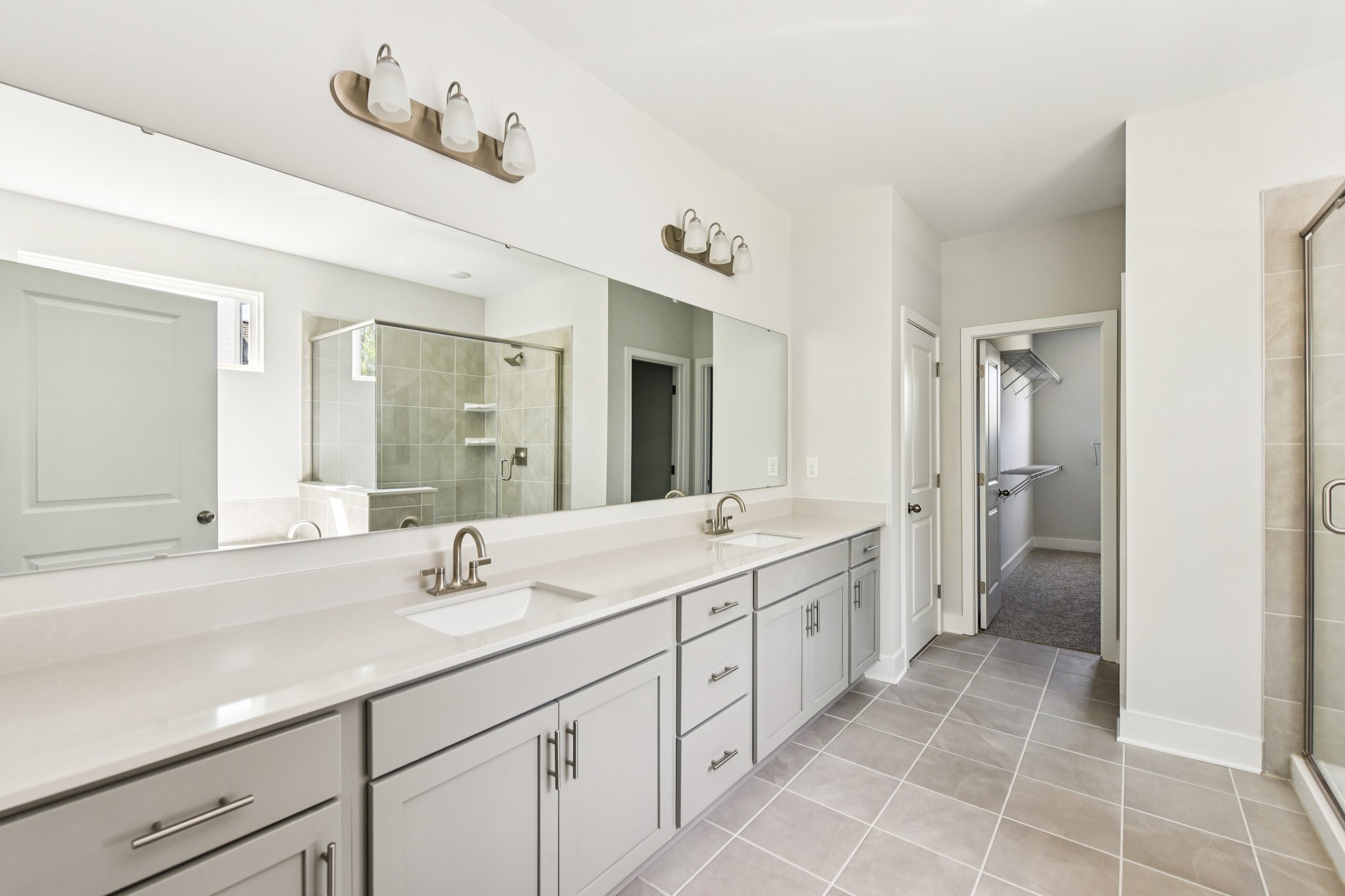 A bathroom with white cabinets.