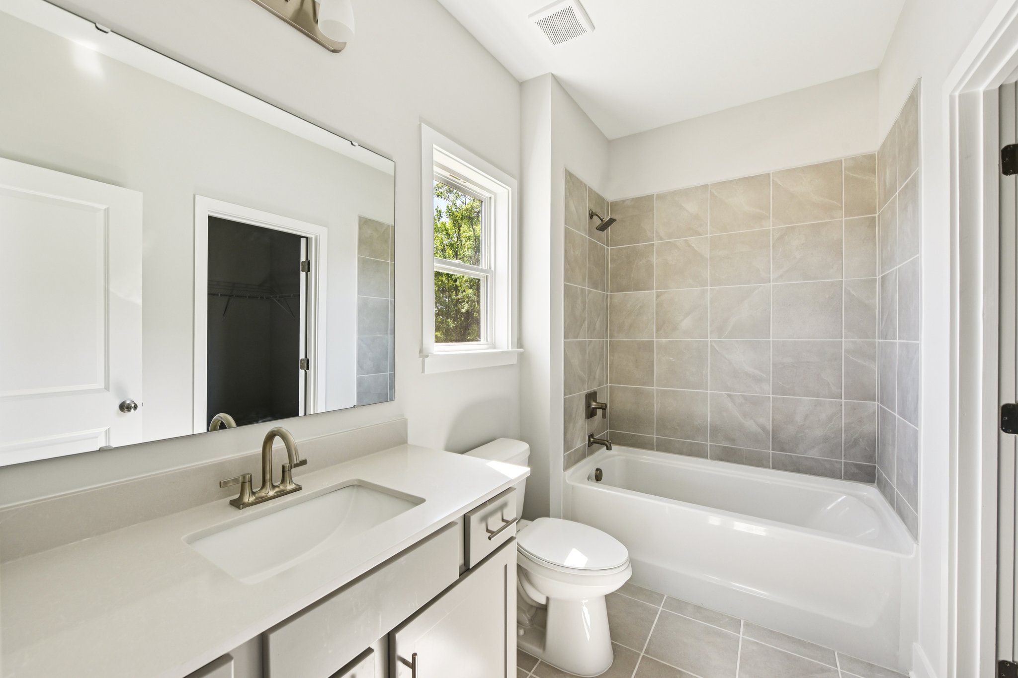 A bathroom with a tub sink and toilet.
