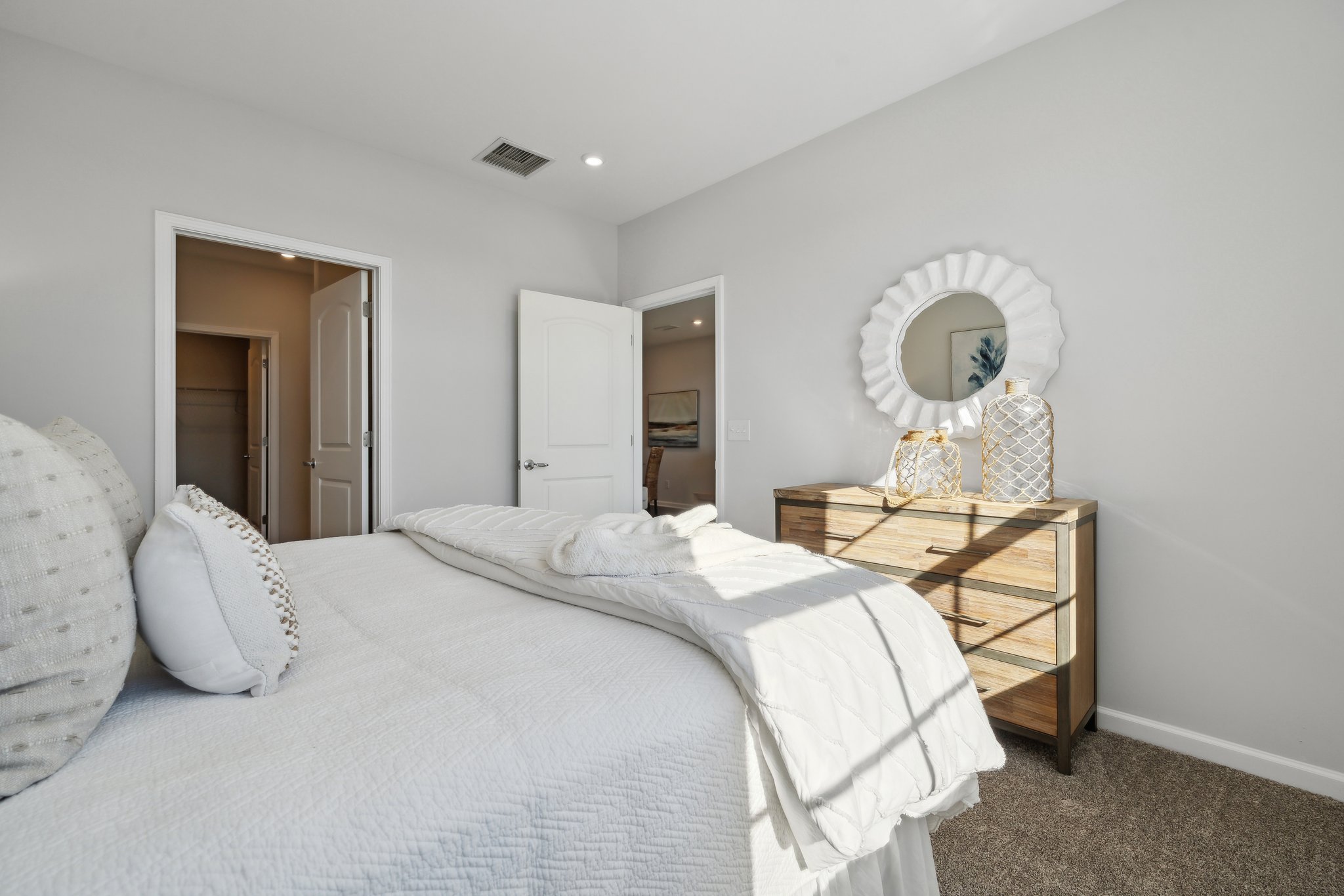 A bedroom with a bed and a table.