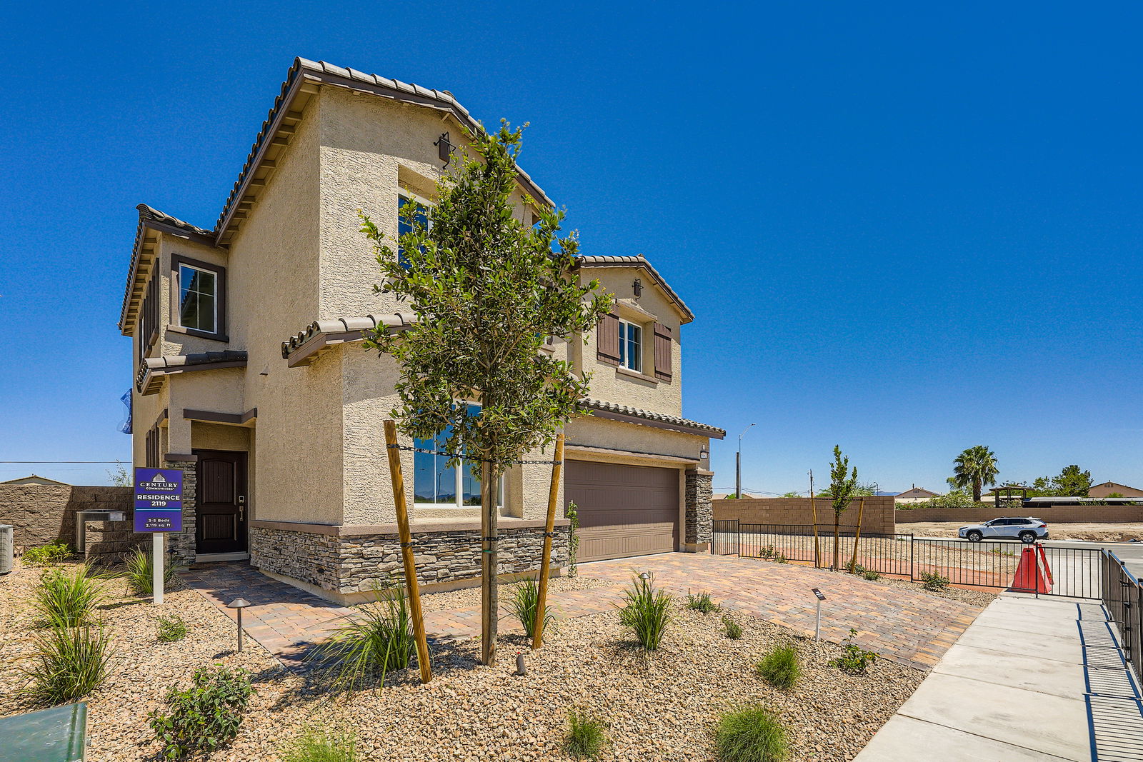 A building with a tree in front.