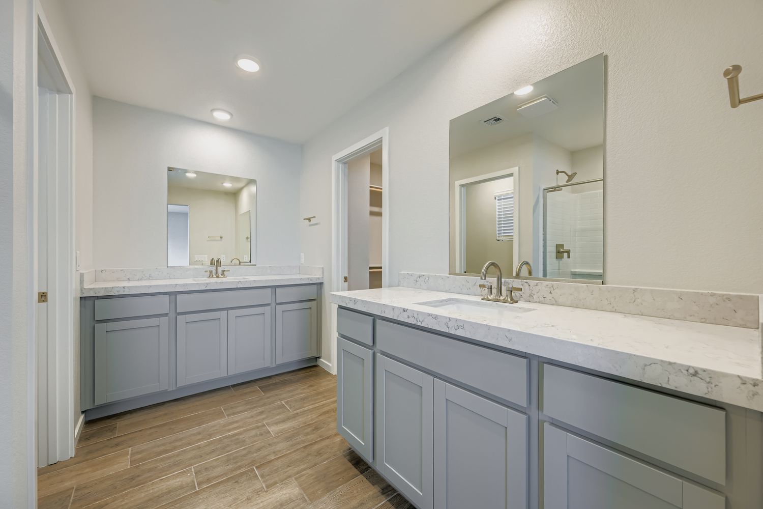 A bathroom with white cabinets.