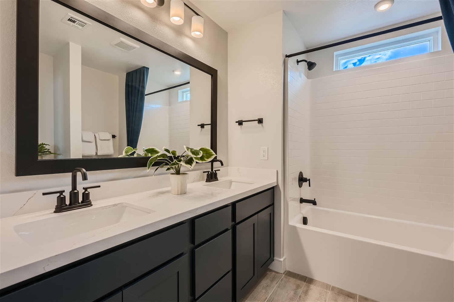 A bathroom with a large mirror.