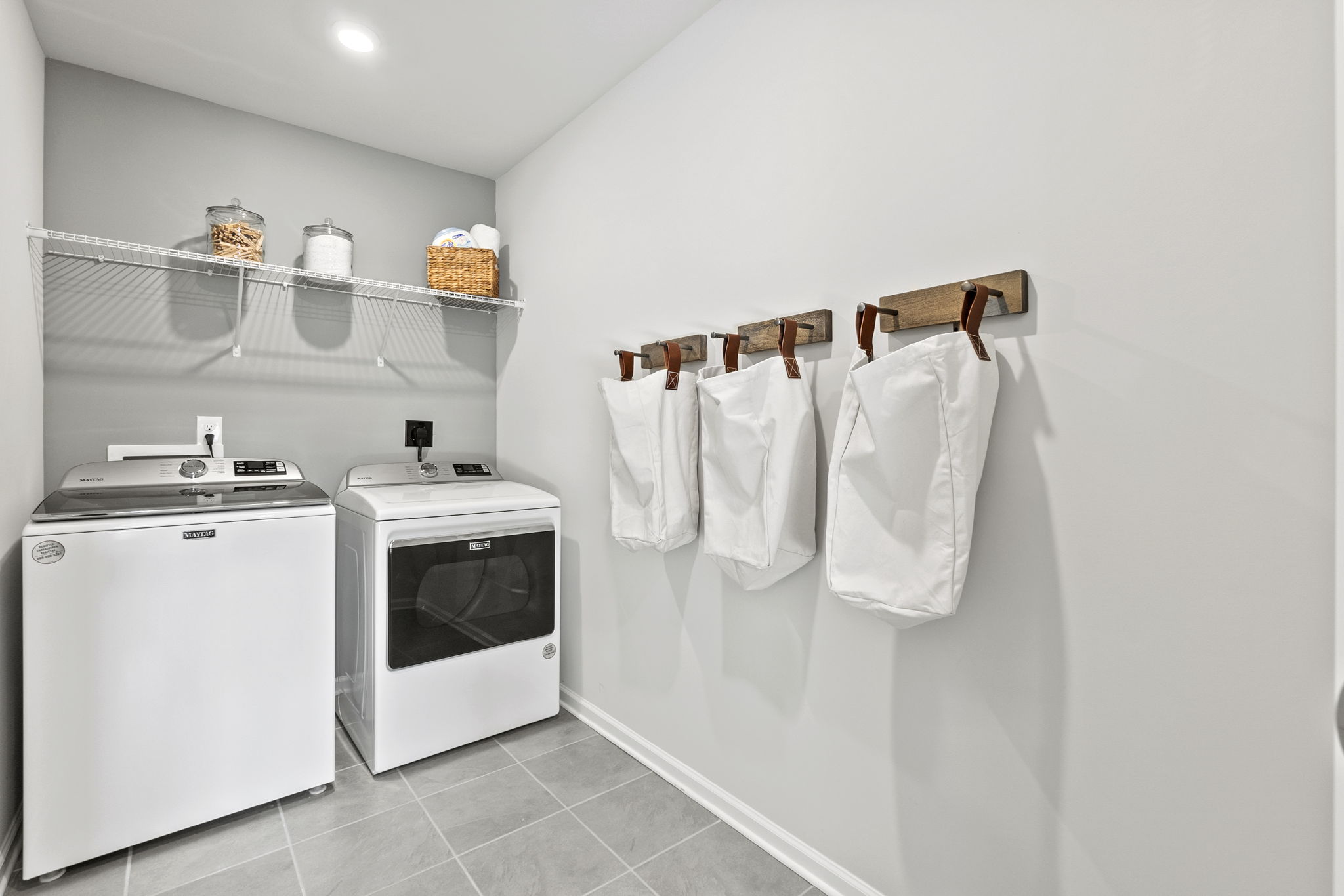 A kitchen with white towels on a rack.