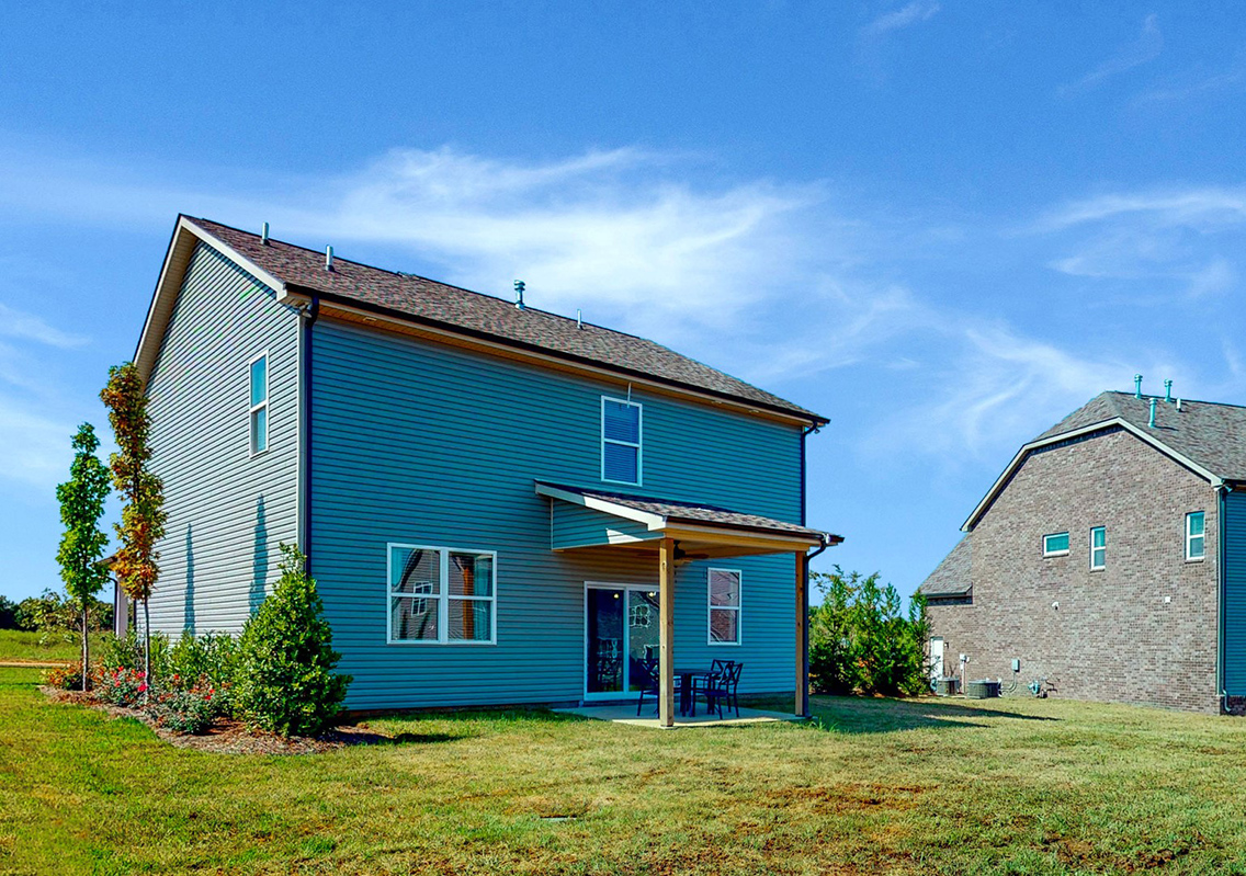A house with a grass yard.