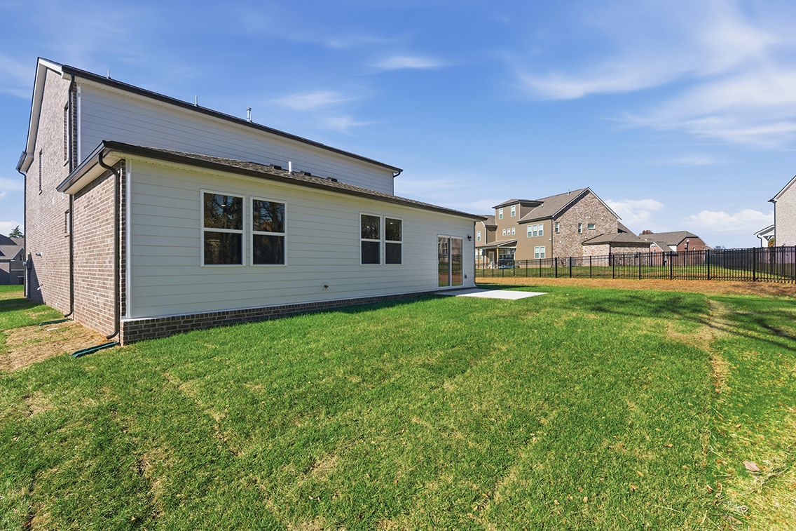 A house with a fence and grass.