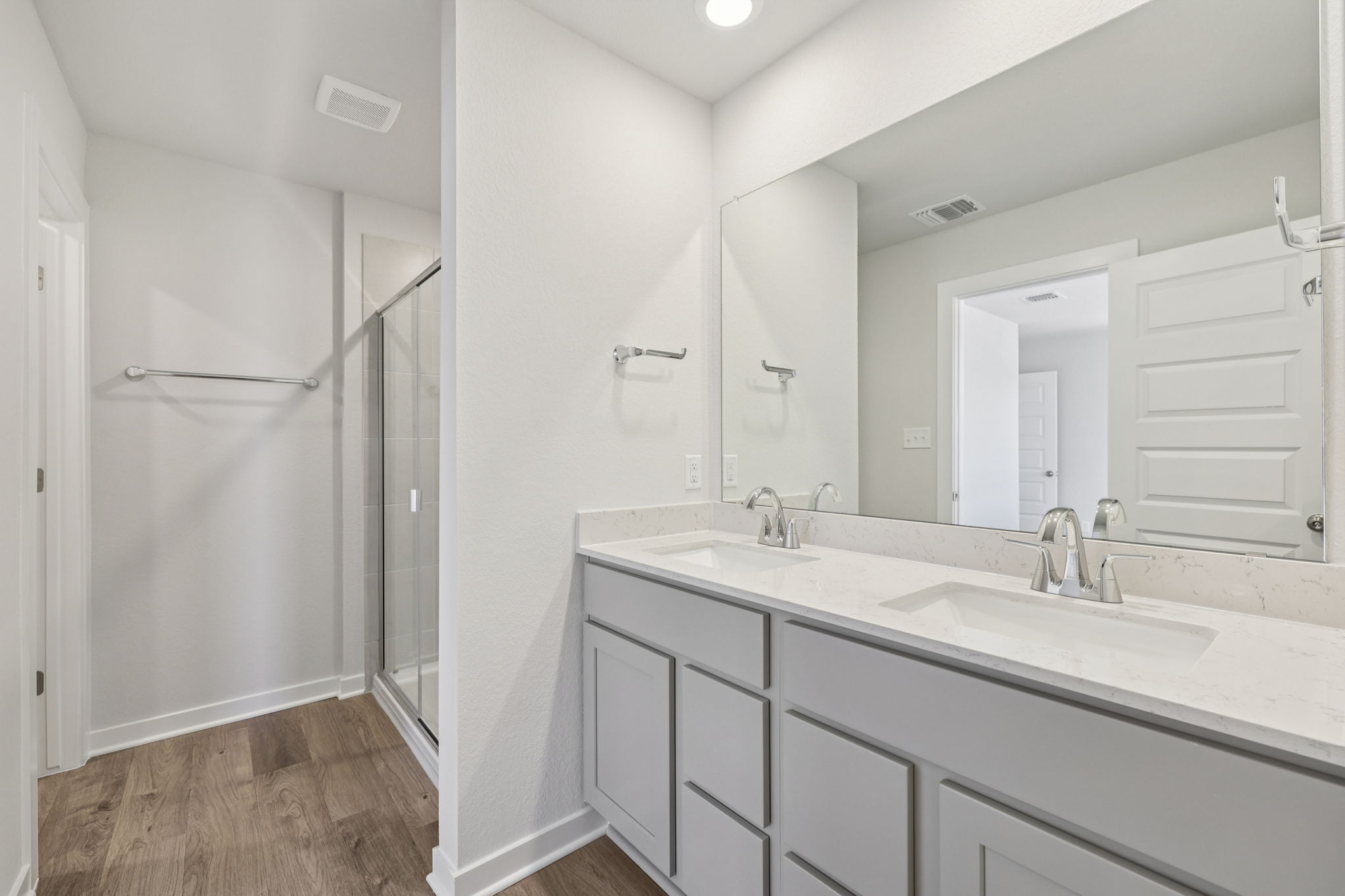 A bathroom with a shower and sink.