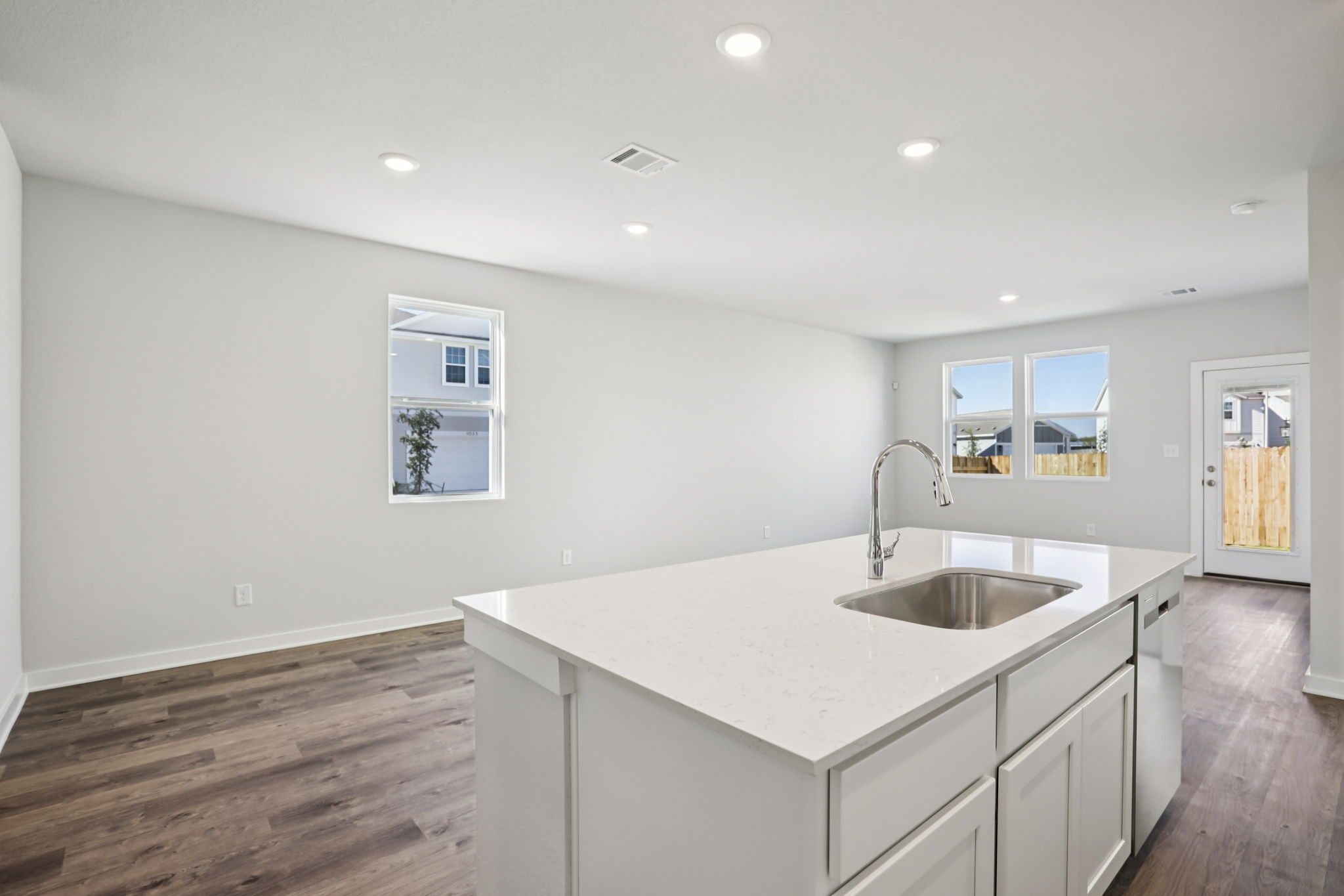 A kitchen with white cabinets.