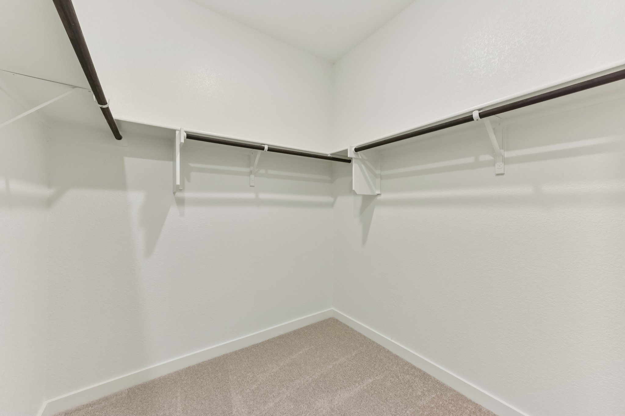 A white wall with a metal railing.