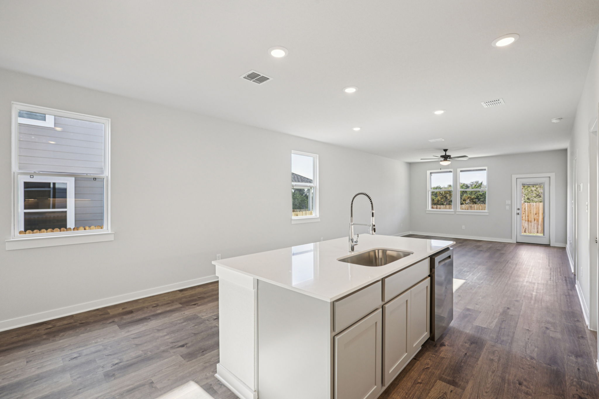 A kitchen with white cabinets.
