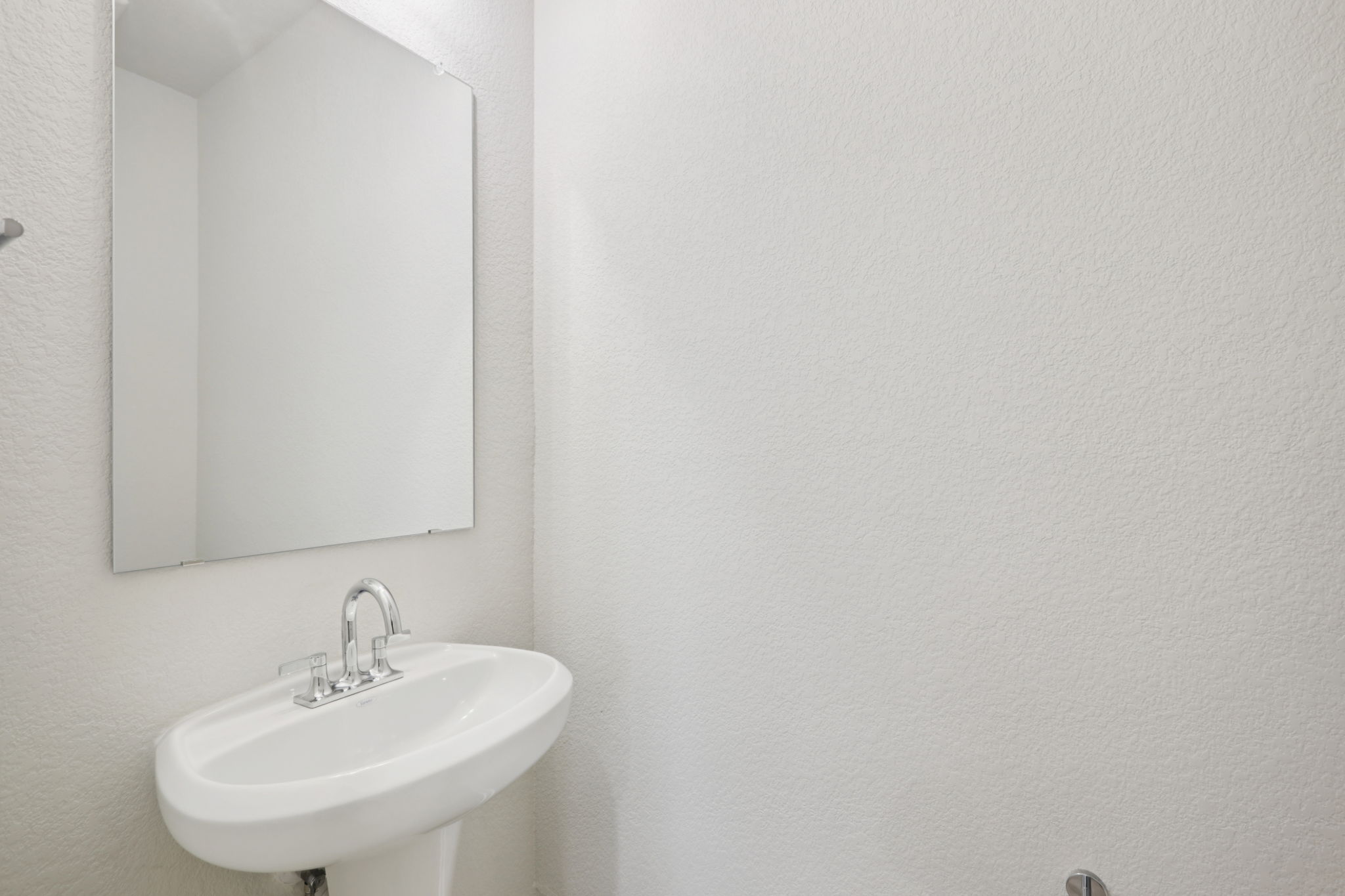 A bathroom with a mirror and sink.