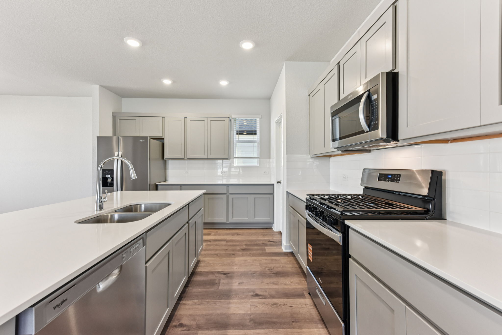 A kitchen with white cabinets.