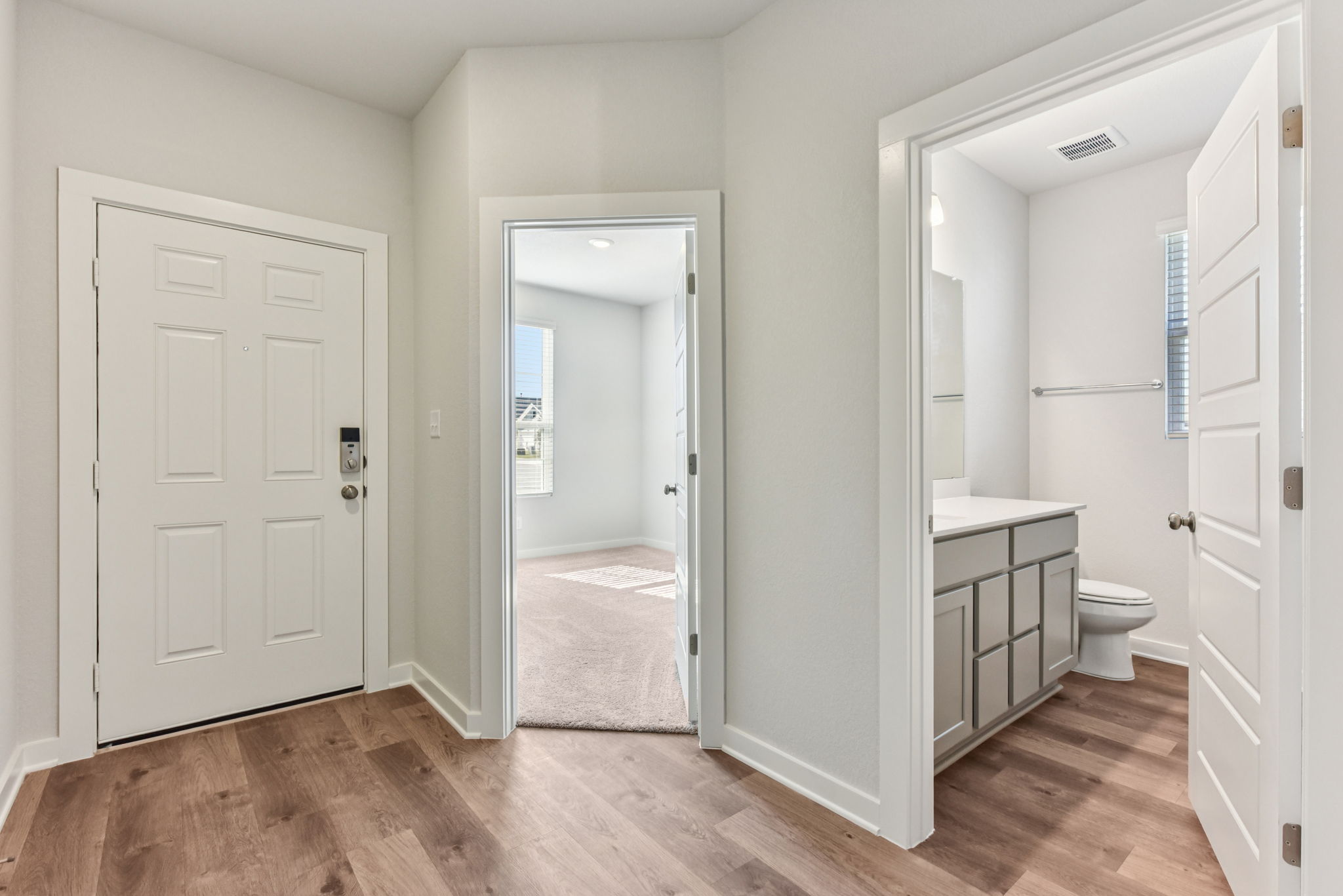 A bathroom with white doors.