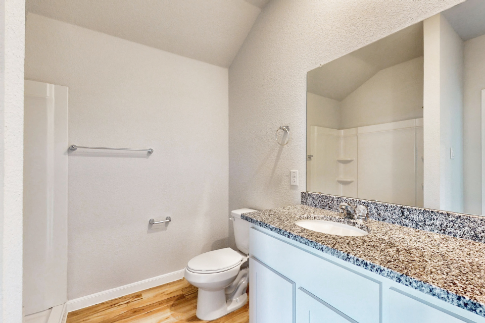 A bathroom with a marble countertop.