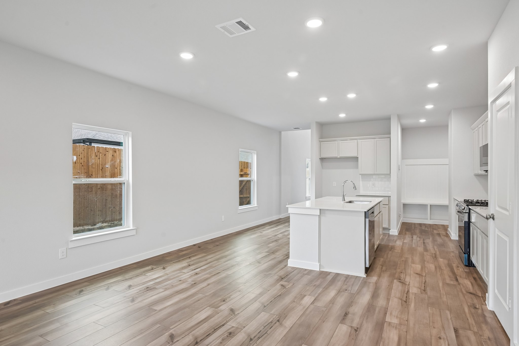 A kitchen with white cabinets.