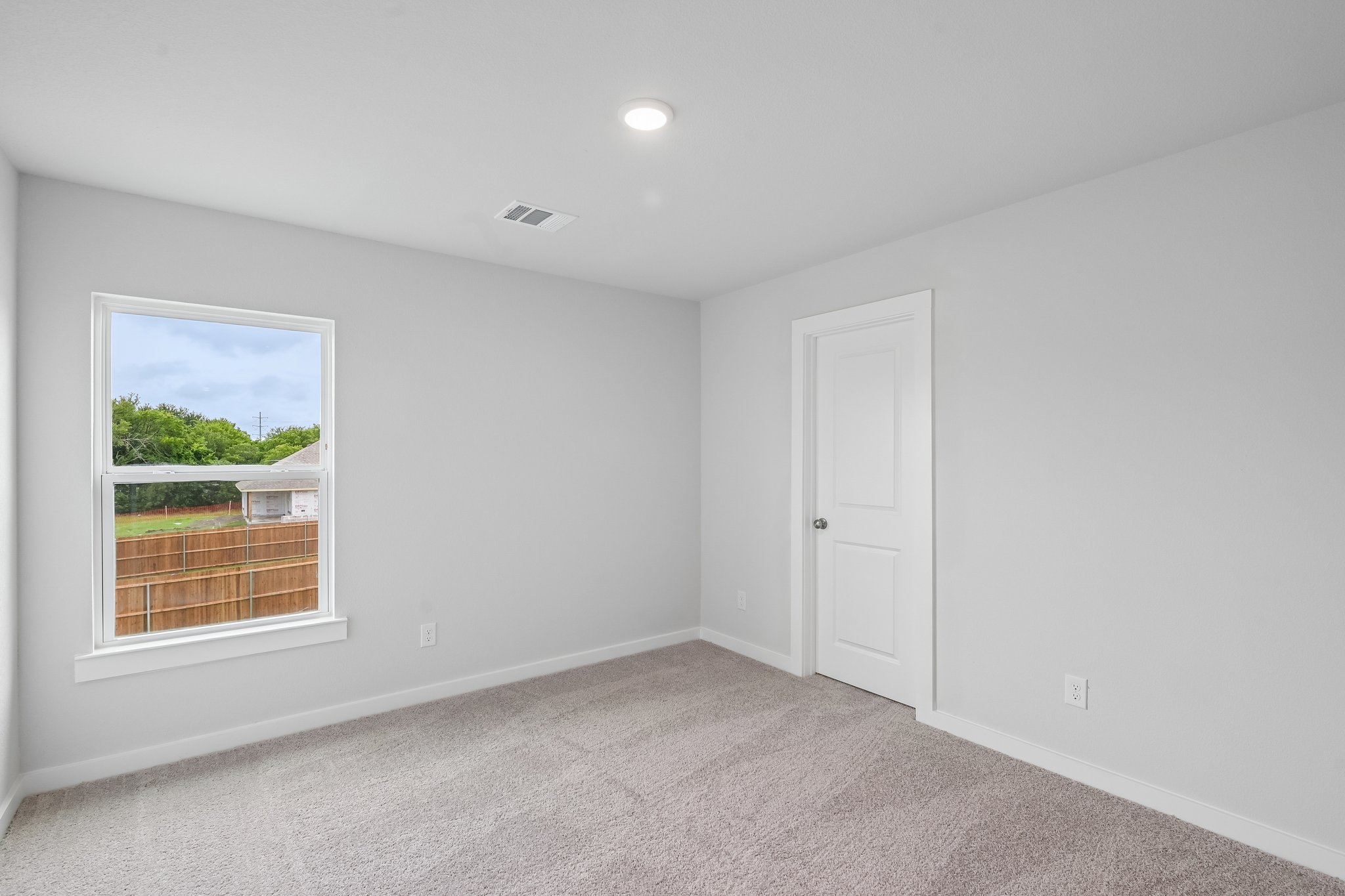 A room with a window and a door.