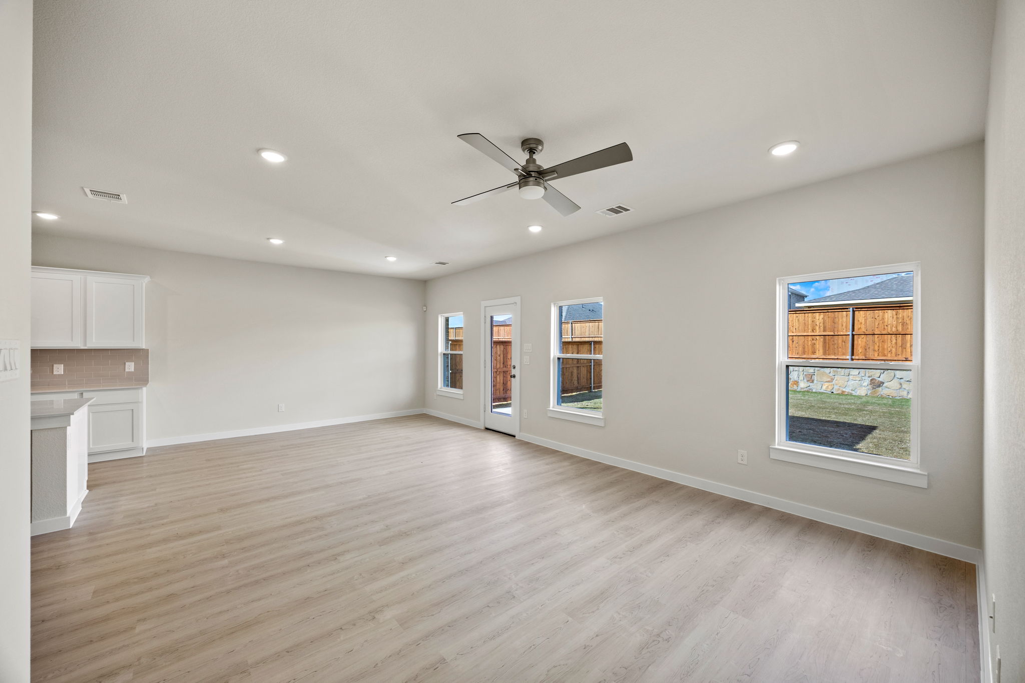 A large kitchen with a wood floor.