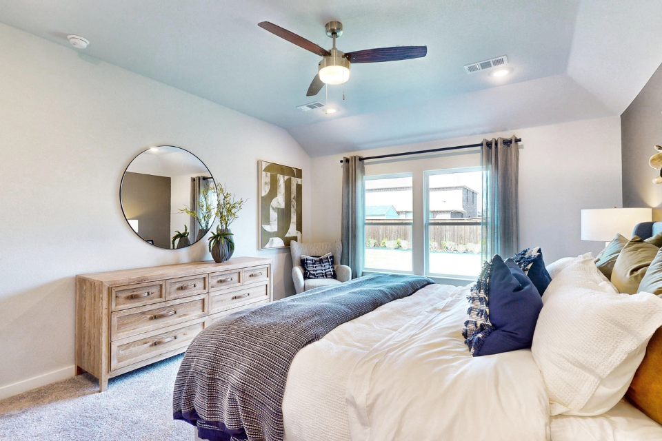A bedroom with a large window.