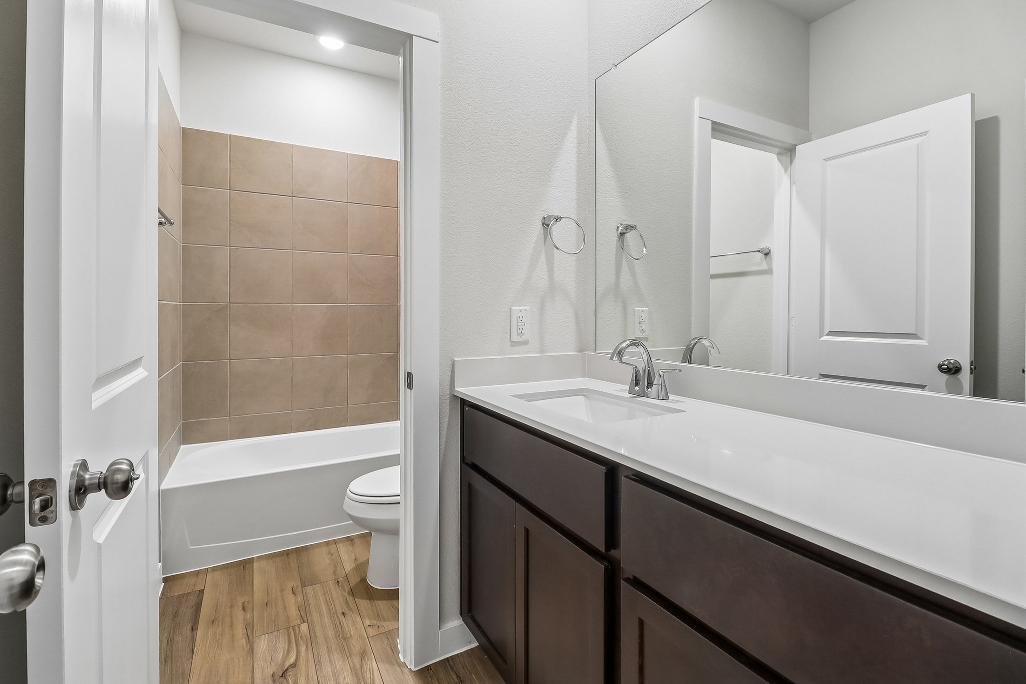 A bathroom with a tub sink and toilet.