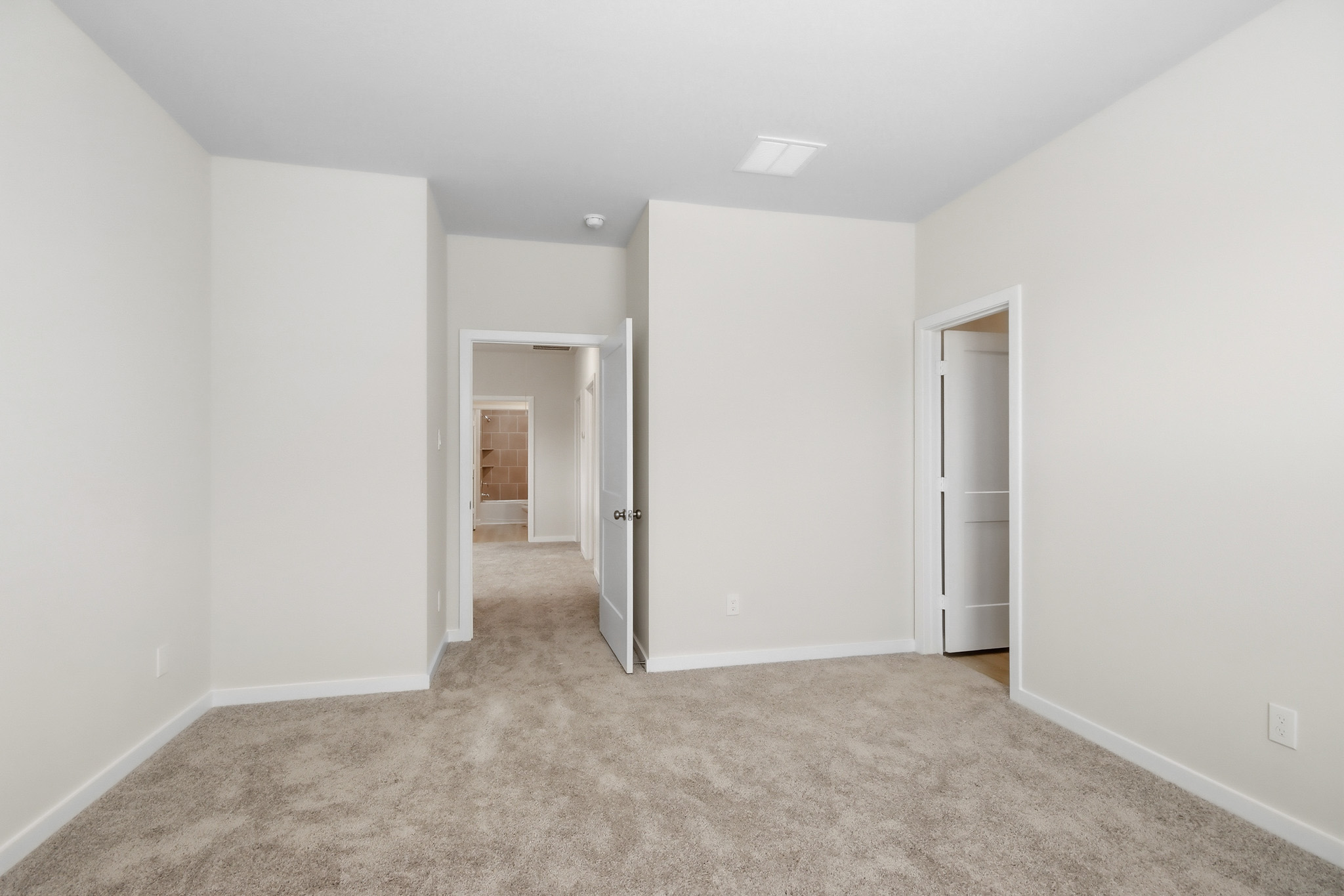 A hallway with white walls.