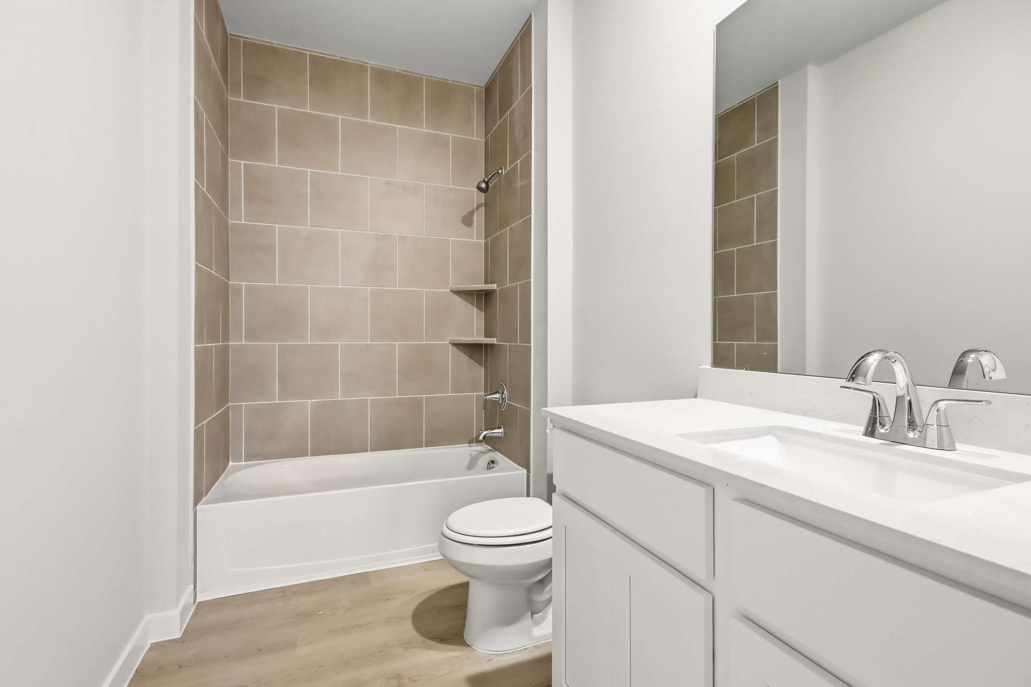 A bathroom with a tub sink and toilet.