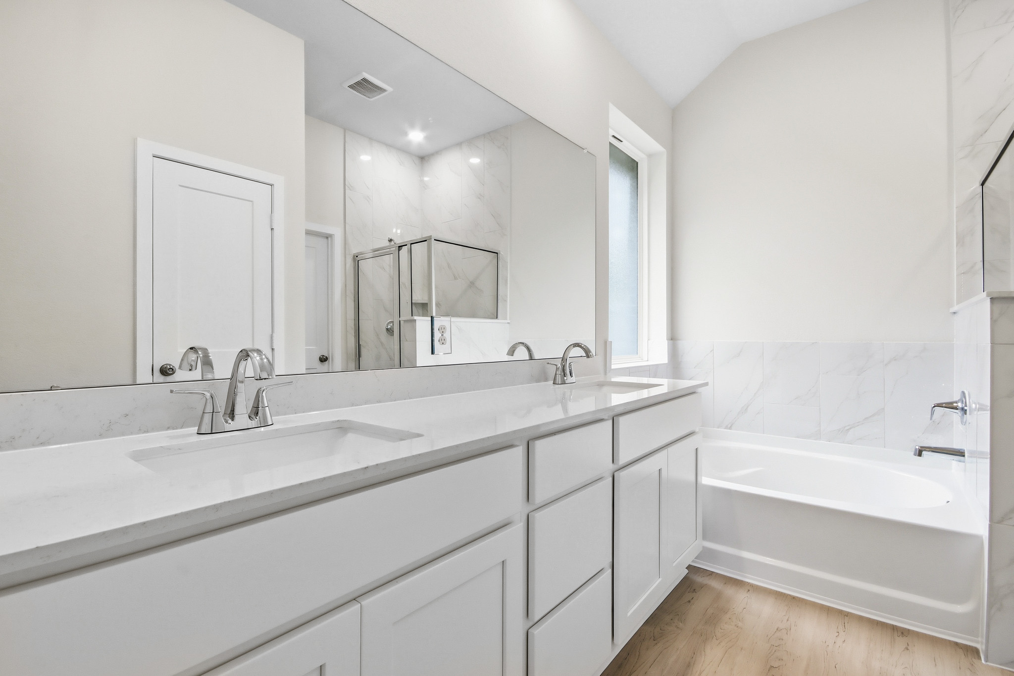A bathroom with a large mirror.