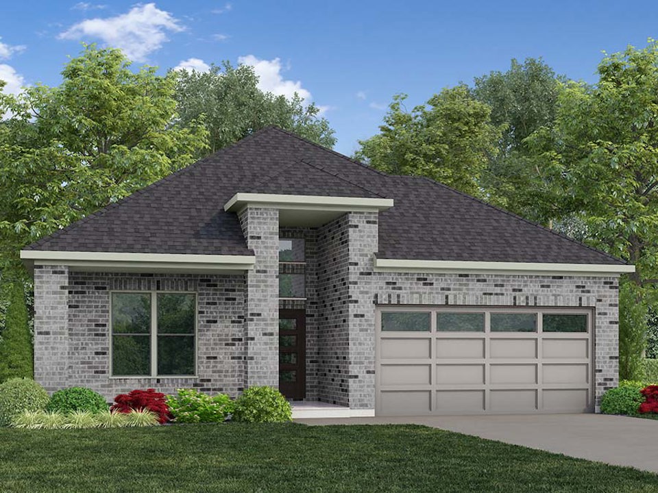 A house with a garage and trees in the back.