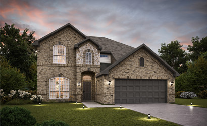 A stone house with a driveway.