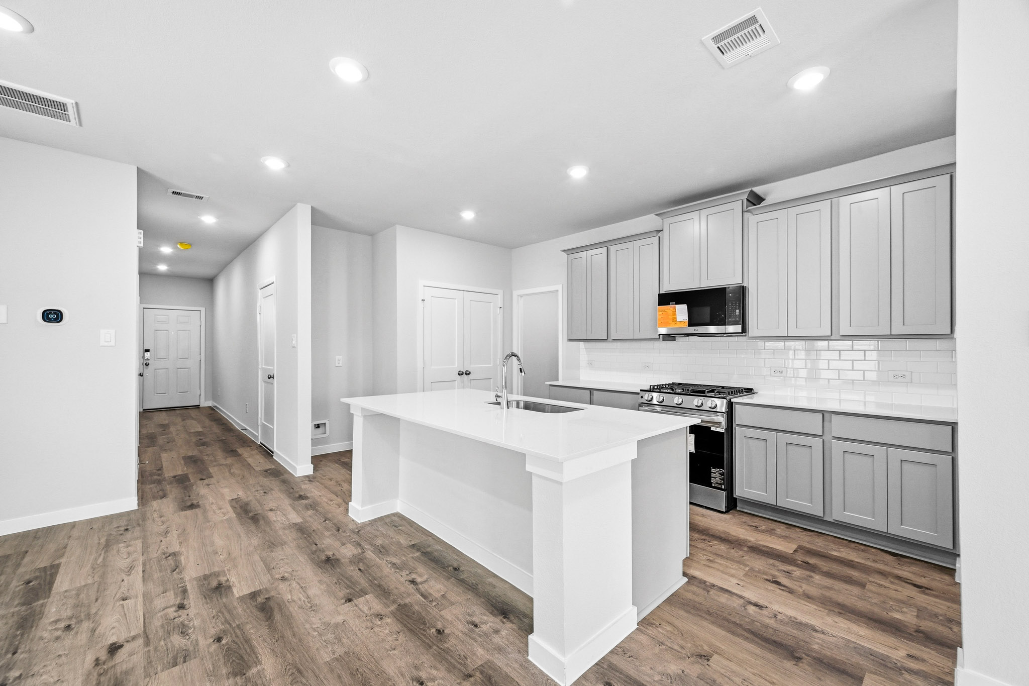 A kitchen with white cabinets.