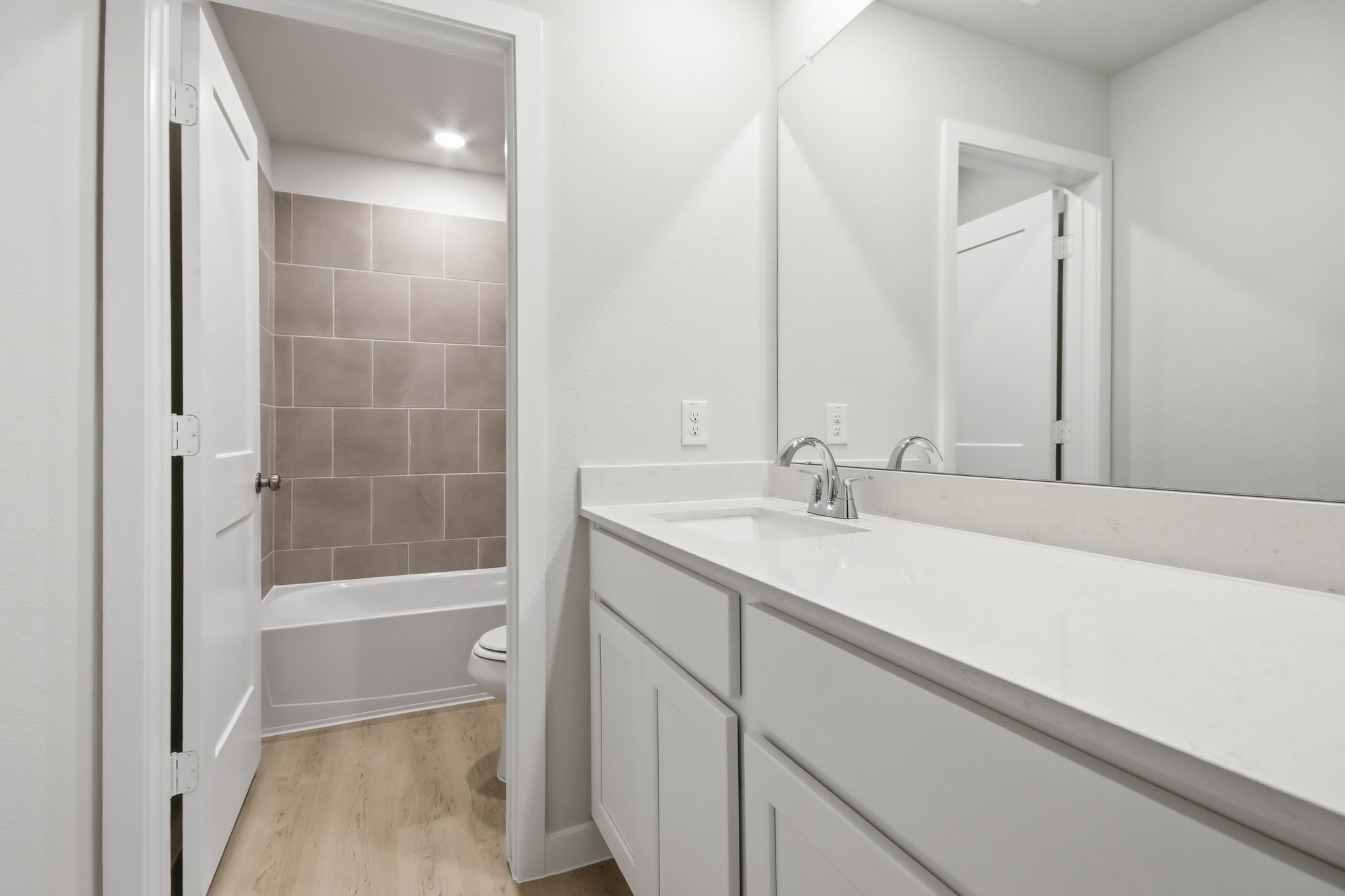 A bathroom with a tub sink and toilet.