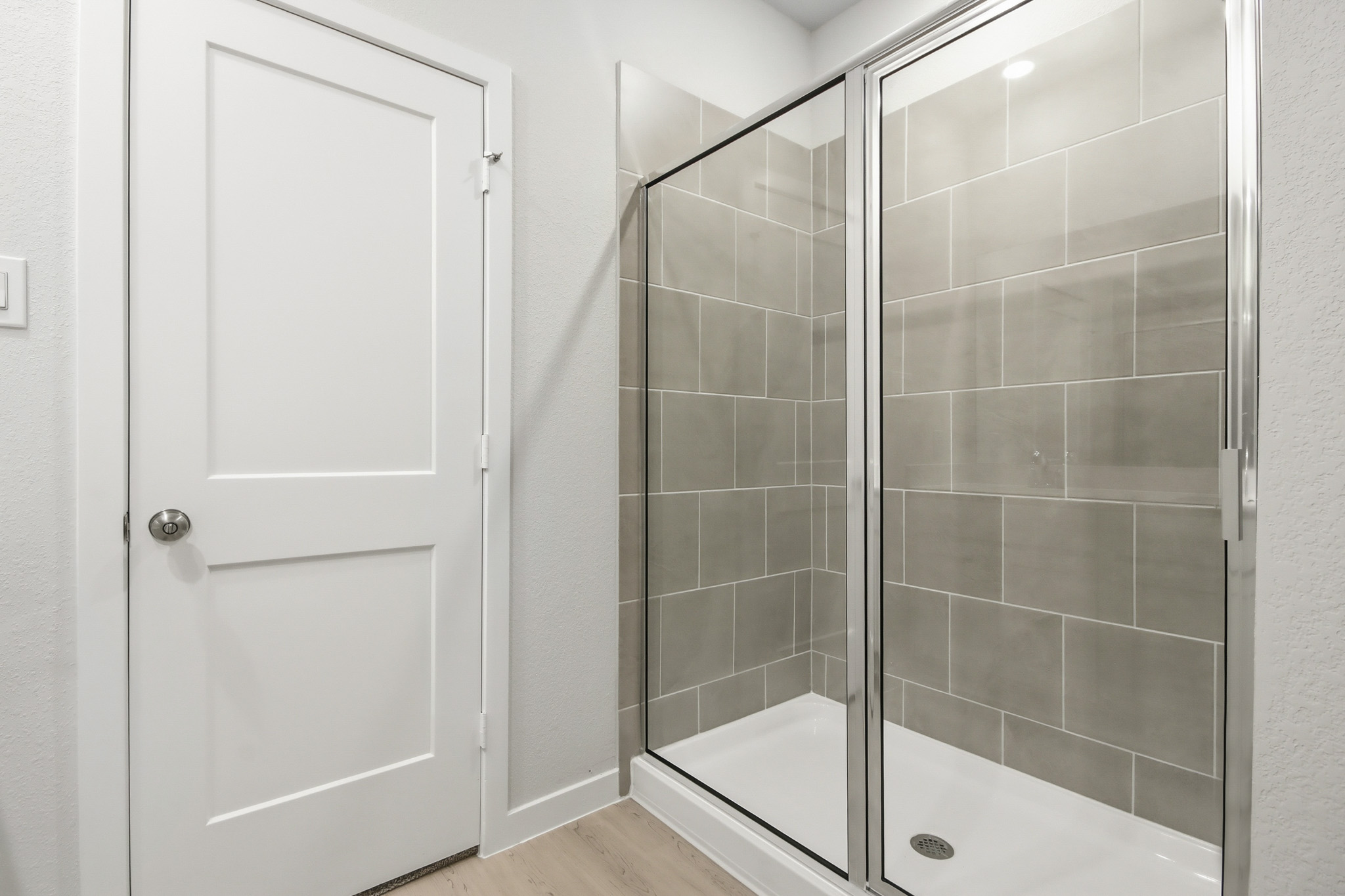 A shower with a glass door.