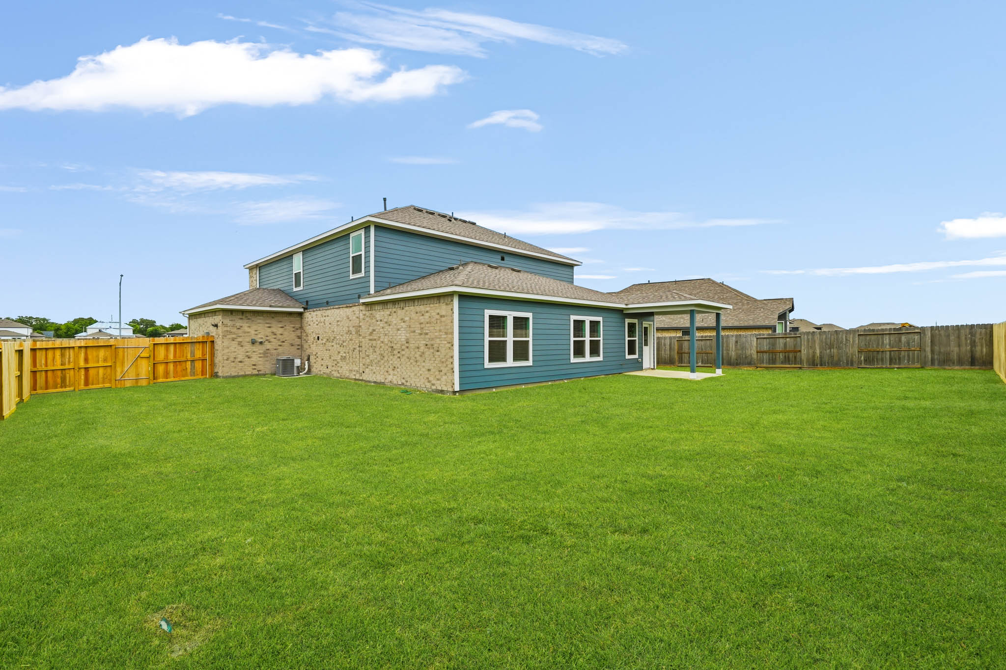 A house with a fence and grass.