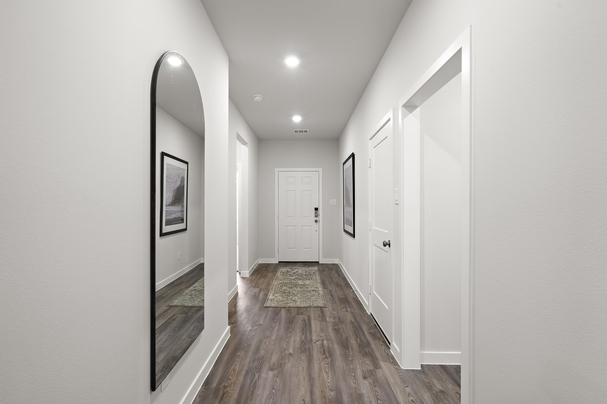 A hallway with white doors.