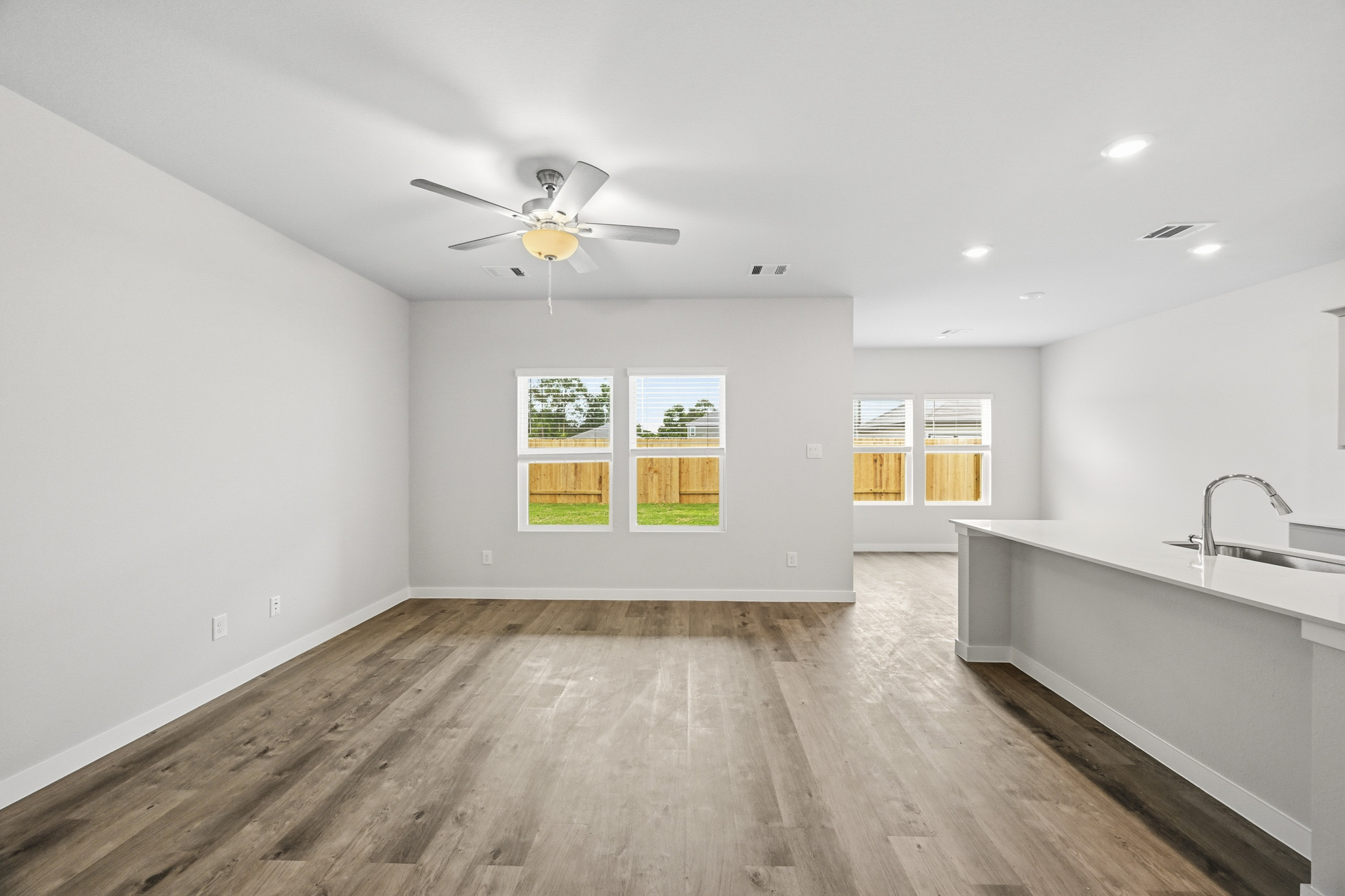 A kitchen with a wood floor.