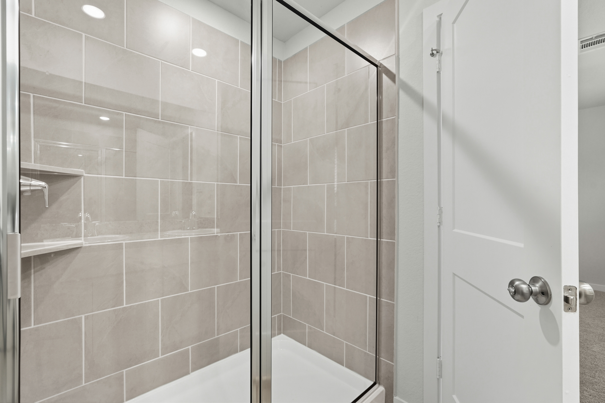 A shower with a glass door.