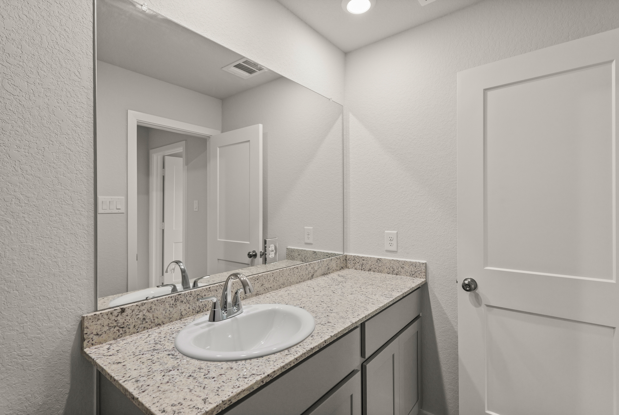 A bathroom with a marble countertop.