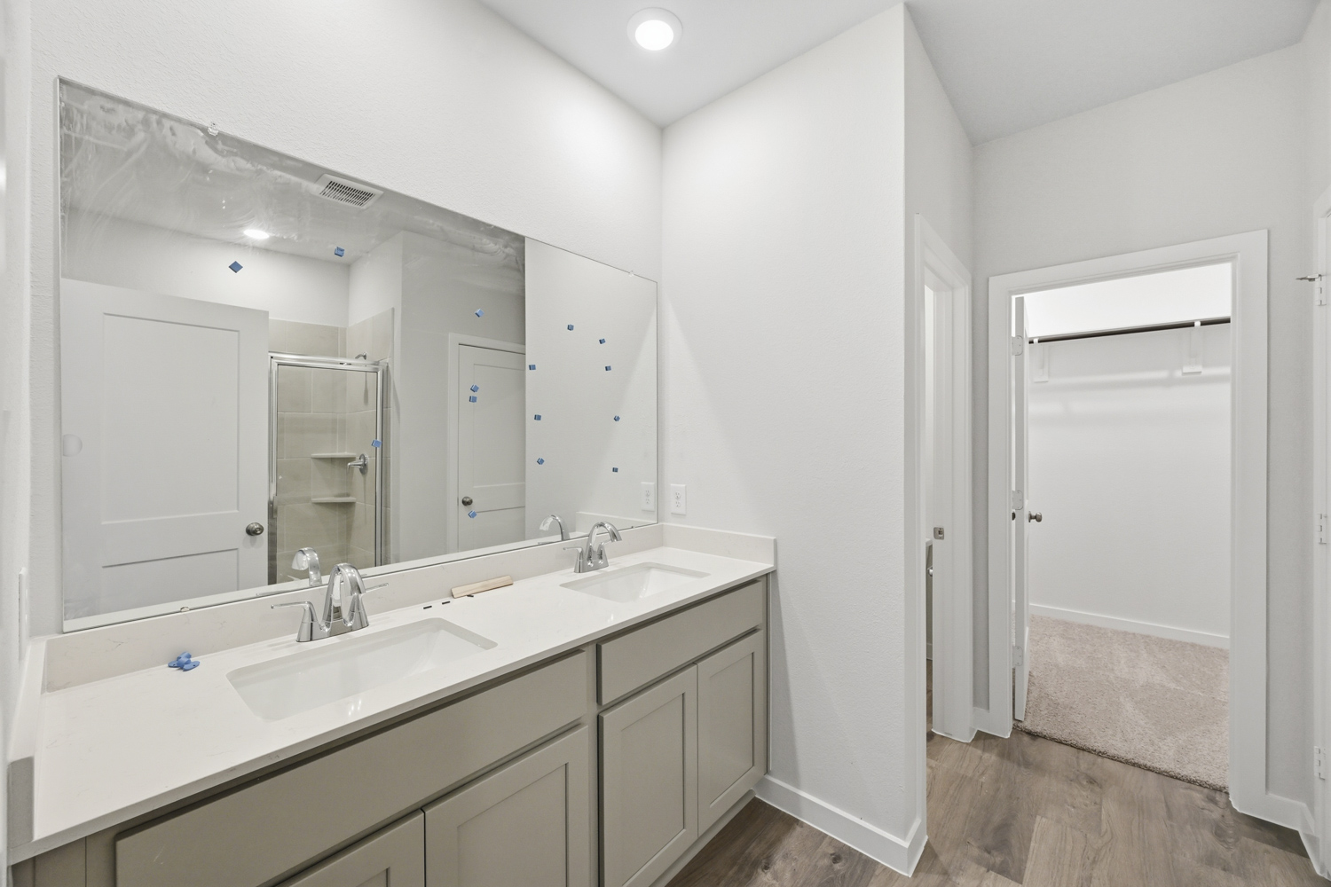 A bathroom with a large mirror.