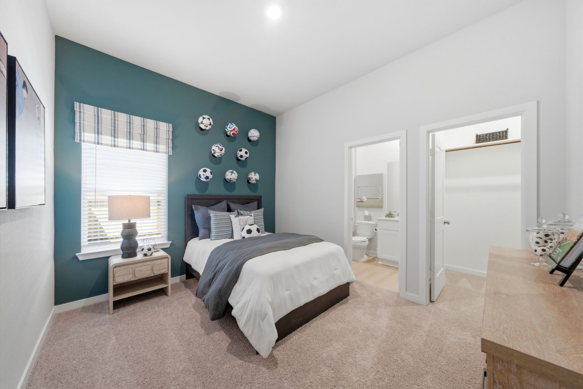 A bedroom with a bed and a desk.