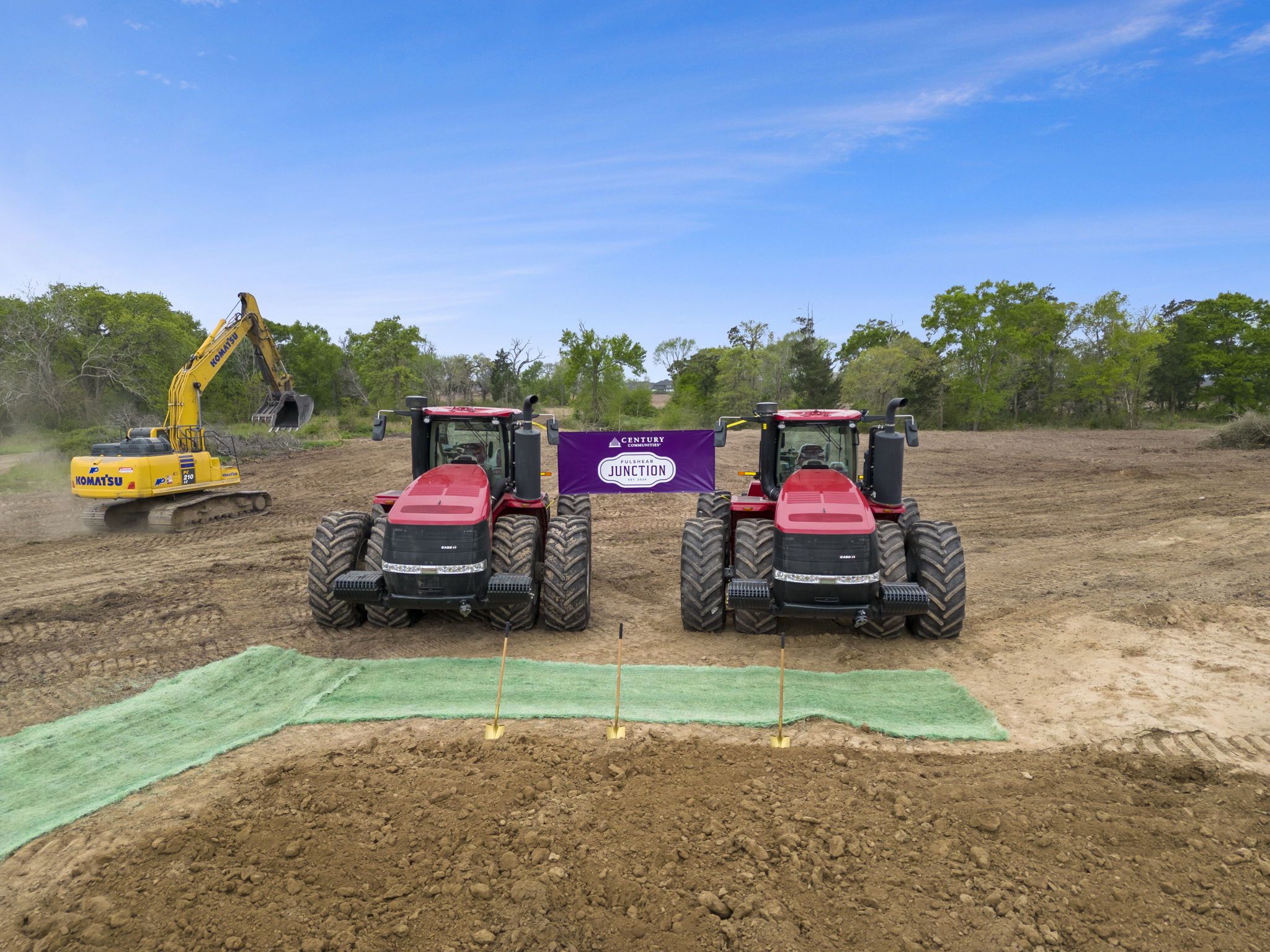 A few tractors in a field.
