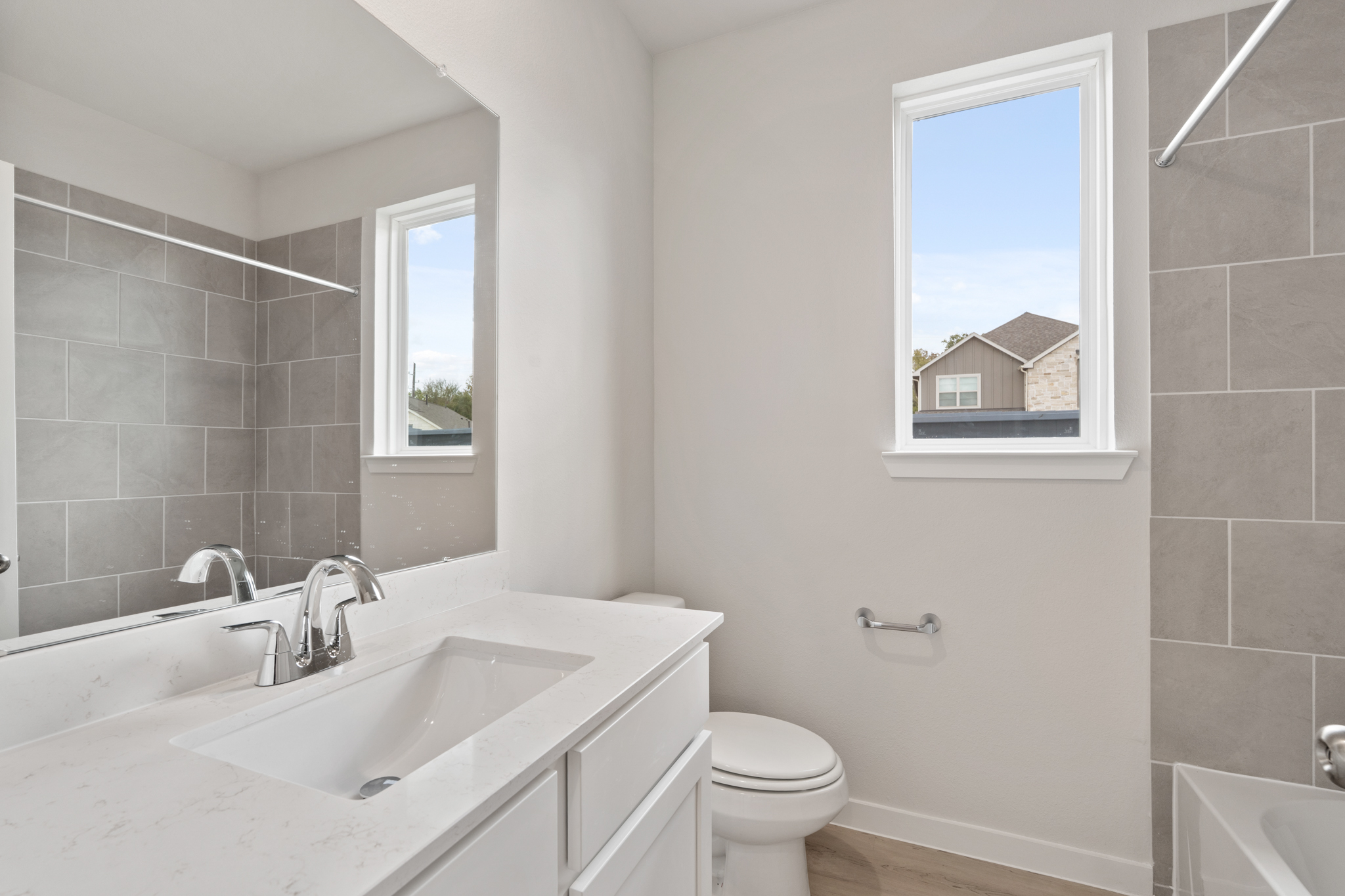 A bathroom with a tub sink and toilet.
