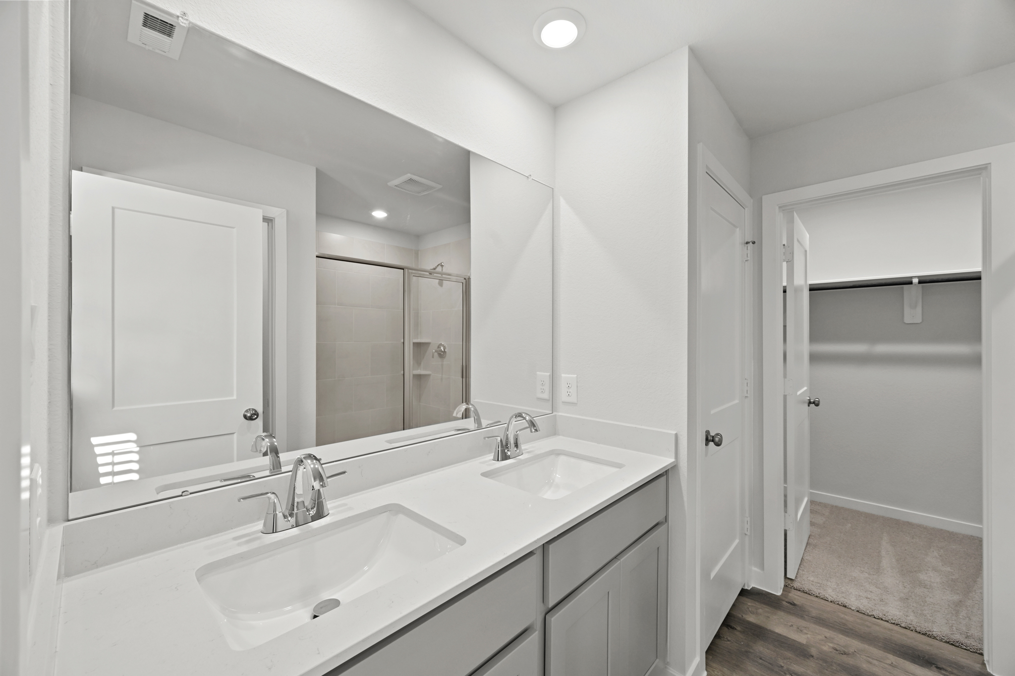 A bathroom with a large mirror.