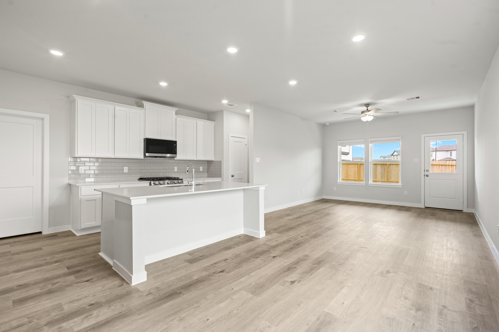 A kitchen with white cabinets.
