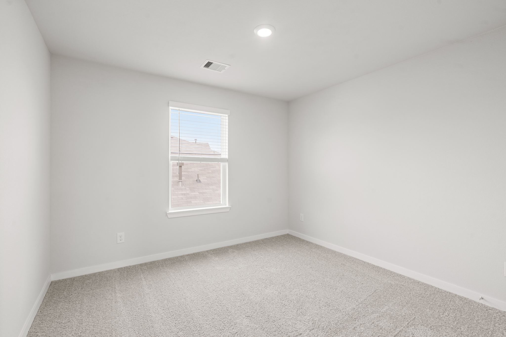 A room with a window and a carpet.