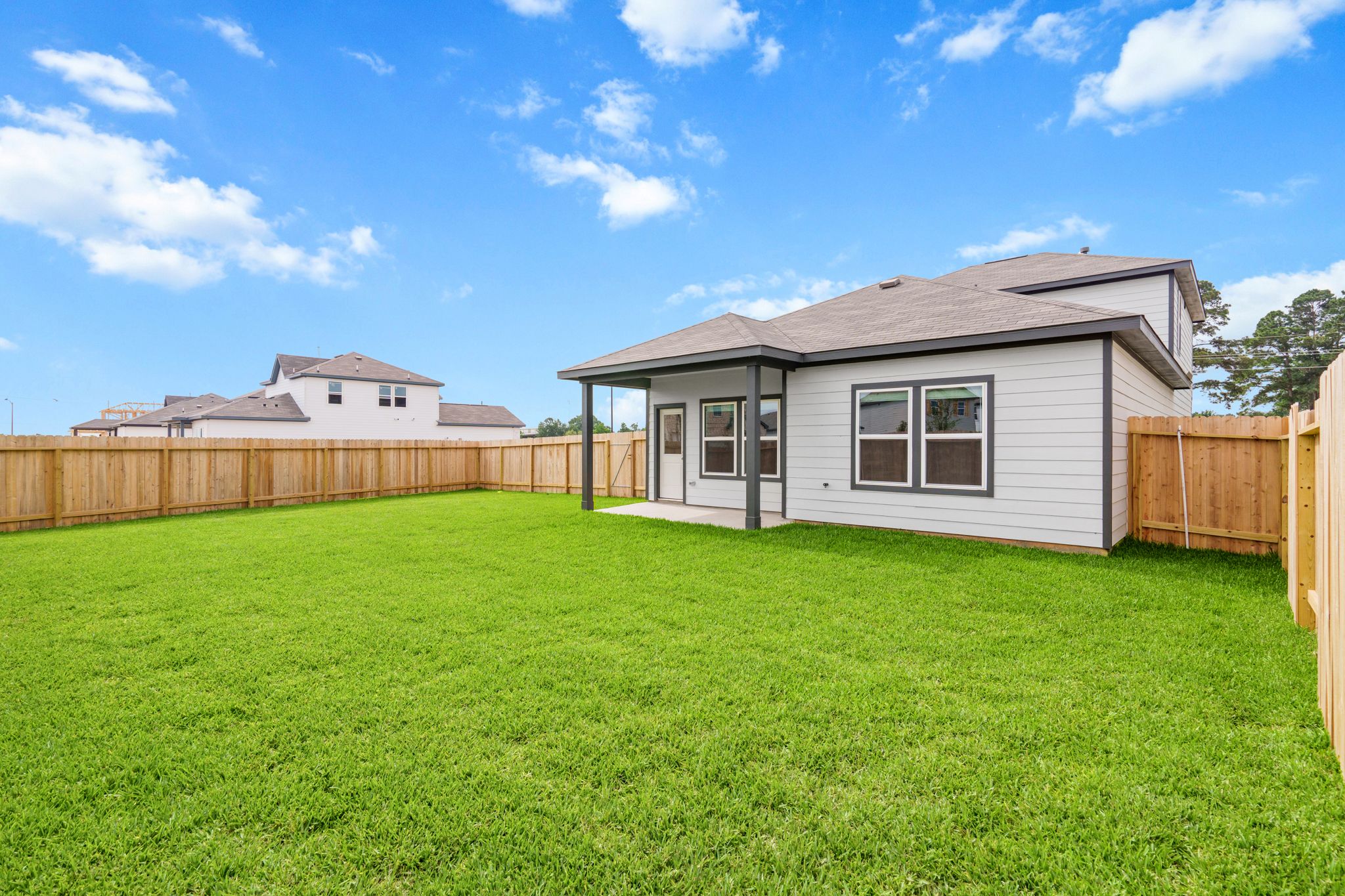 A house with a fence and grass.