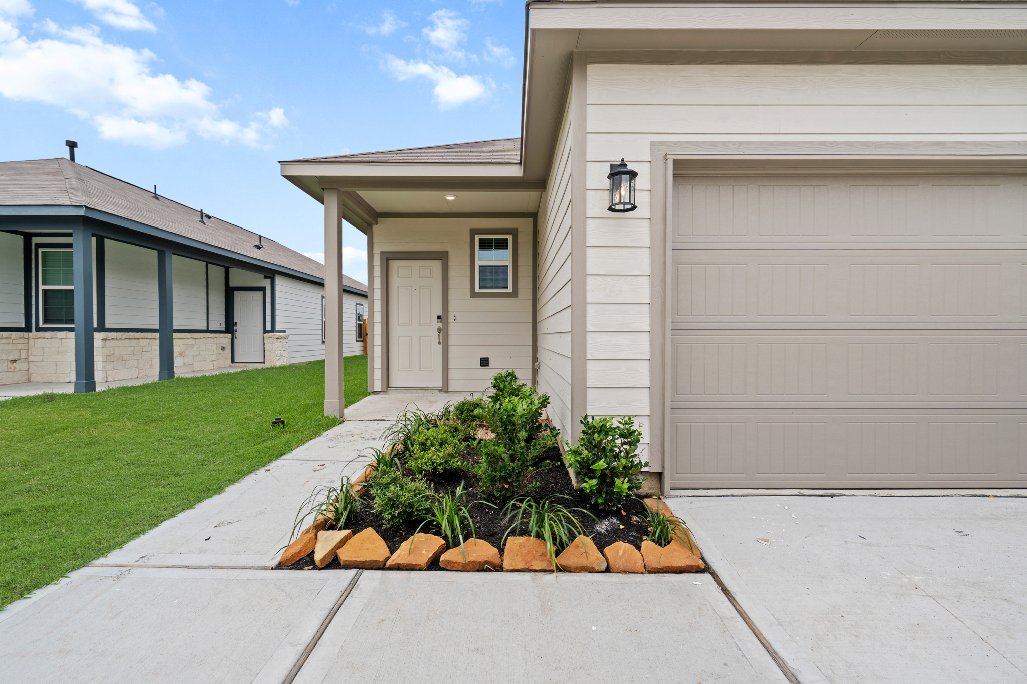 A house with a garage and a small garden.