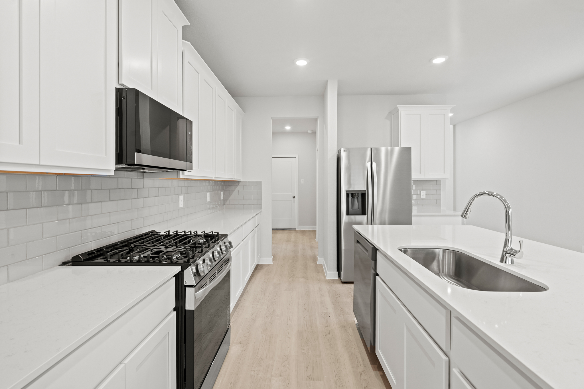 A kitchen with white cabinets.