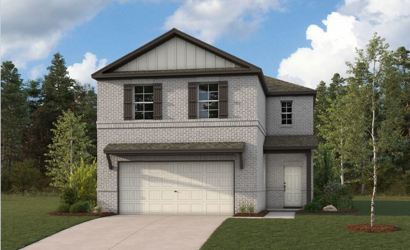 A house with a garage and trees.
