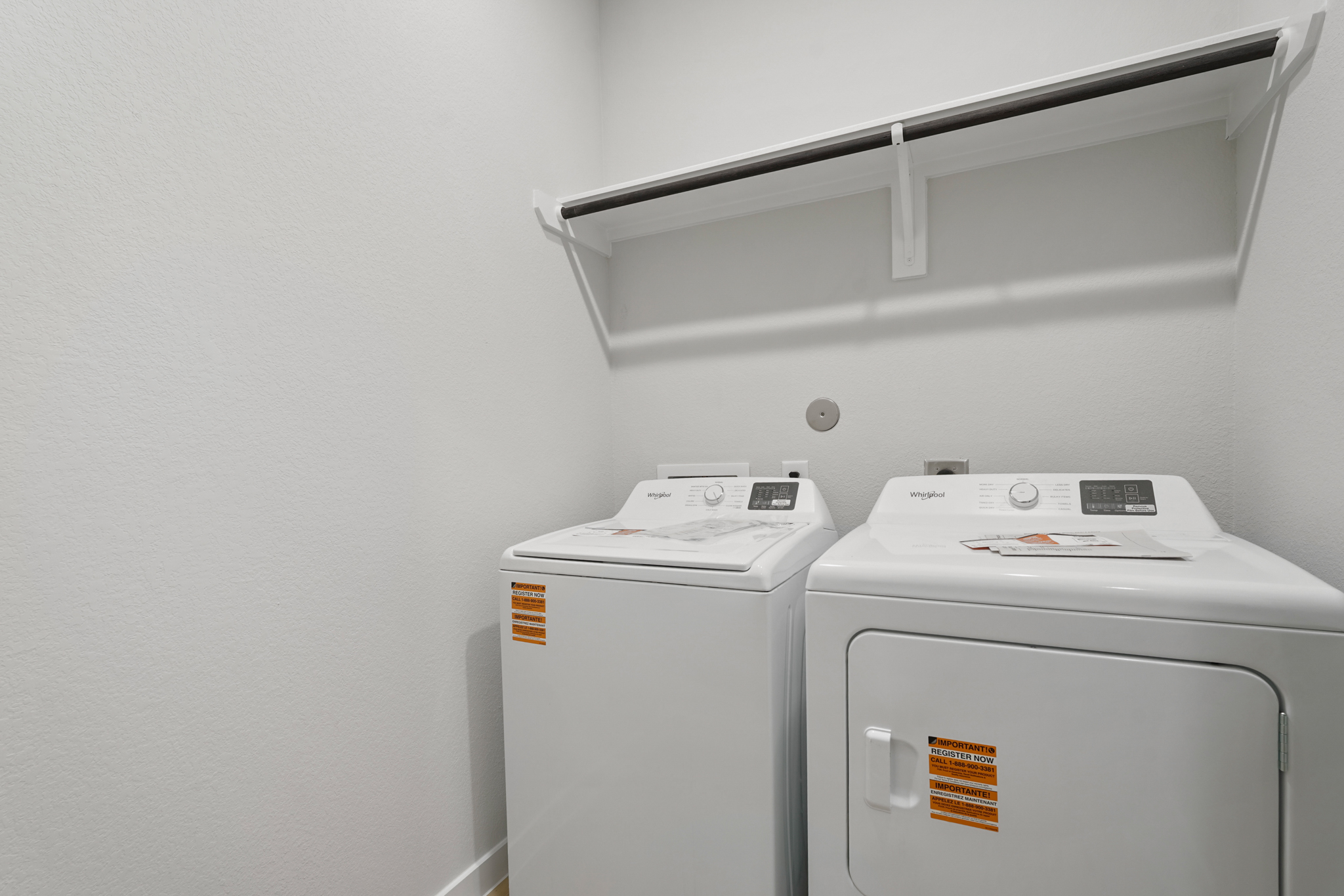 A white machine with a white wall.