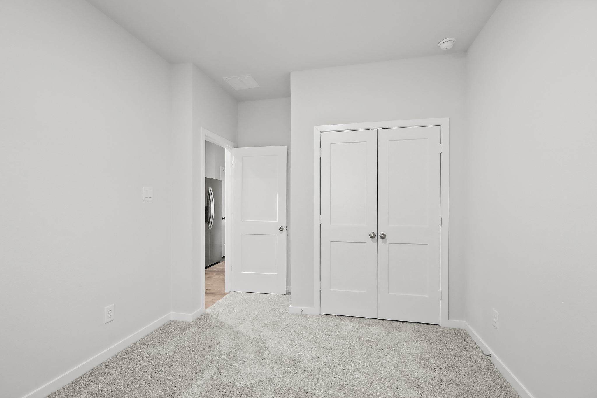 A hallway with white doors.