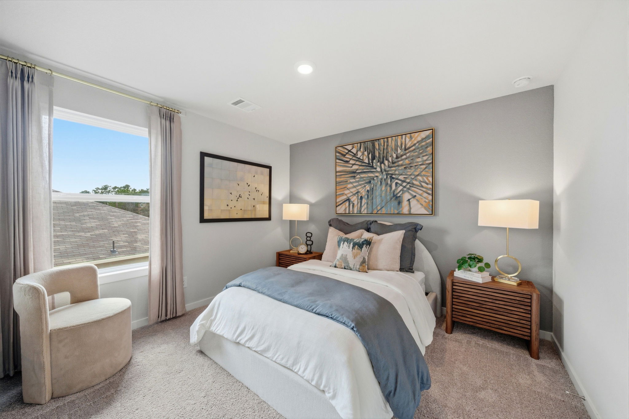 A bedroom with a large window.