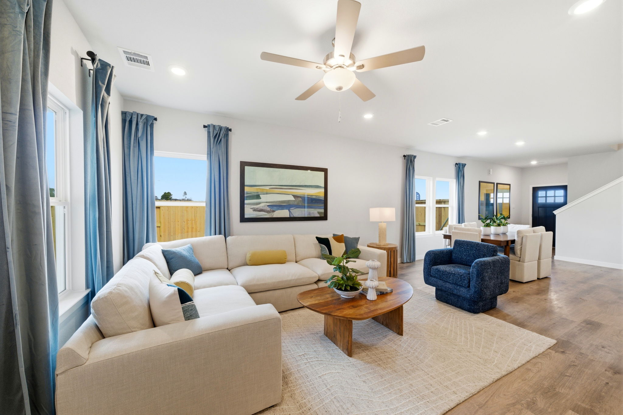 A living room with a ceiling fan.